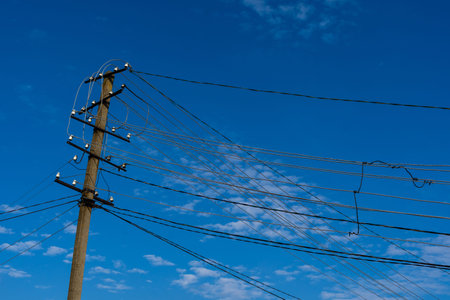 Barbed wire fence against a blue skyの写真素材
