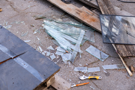Stained glass shards and waste in a glass studio container. The hot glass is cut with special scissors into the vessels, where it burns and cracksの写真素材