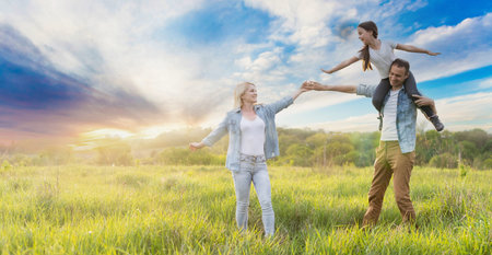 Young happy family in a fieldの写真素材