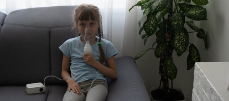 Little girl making inhalation with nebulizer at home. child asthma inhaler inhalation nebulizer...