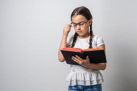 Bible, Child, Christianity. little girl holding a bibleの写真素材