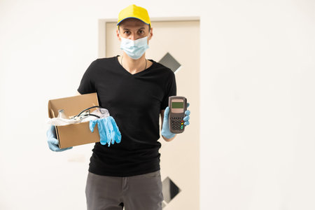 Delivery of medical equipment to the hospital. People in protective suits hand over boxes.の写真素材