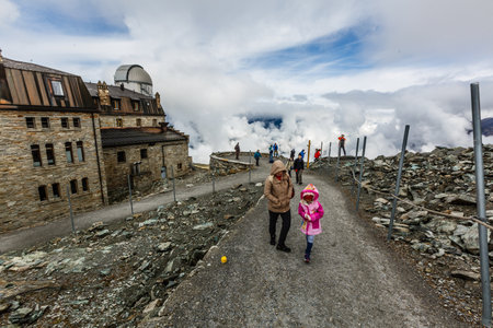 Gornegrat, Switzerland - August 12, 2019: people on the Gornergrat on the cloudy day. The Gornergrat (English: Gorner Ridge) is a rocky ridge overlooking the Gorner Glacier in the canton of Wallis.のeditorial素材