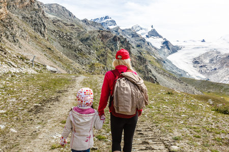Hiking - hiker woman on trek with backpack living healthy active lifestyle. Hiker girl walking on...