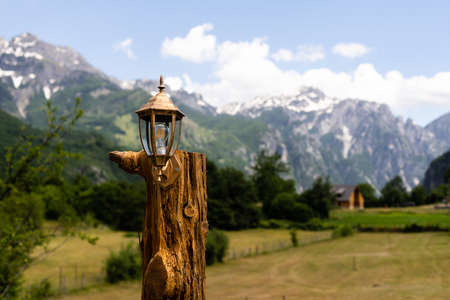 Glowing street lamp against the background of mountains and sky close-up.の写真素材