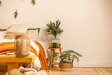 Cozy winter morning. Christmas tree branches near the bed .Christmas interior. Christmas concept. Pillows, pine cones, gypsophila and fir tree branchの写真素材