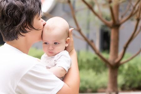 Portrait of beautiful happy smiling mother with baby outdoor