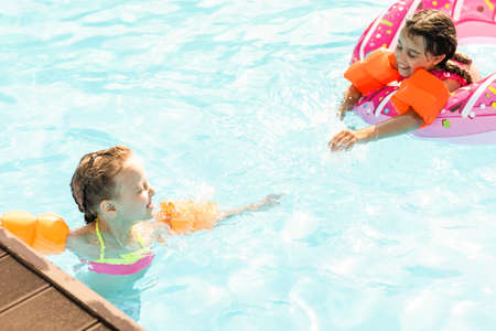 Now pool adventure is waiting for us. Children in the pool.の写真素材