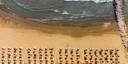 Sand beach aerial, top view of a beautiful sandy beach aerial shot with the waves rolling into the shoreの写真素材