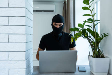 The hacker is hacking the computer. Steals information.の写真素材