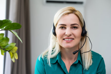 Pretty happy businesswoman looking at camera, head shot portrait of friendly attractive life coach posing with wide toothy smile, successful company manager feeling motivated, loves her job.の写真素材
