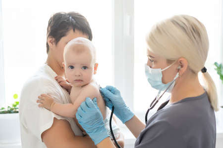 doctor with newborn on a whiteの写真素材