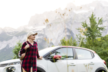 Travel - young beautiful hipster woman in hat travel by car, rent a car in vacations.