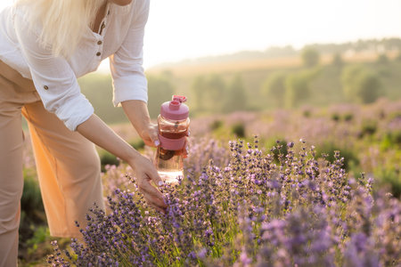 woman with bottle of water in lavender field