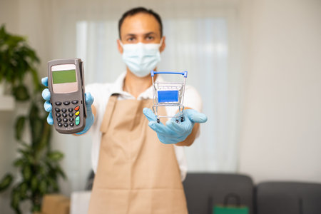 Bank terminal for contactless payment. Young man holds a terminal in his hands