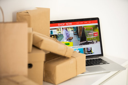 Online shopping - Paper cartons or parcel on a laptop keyboard. Shopping service on The online web...