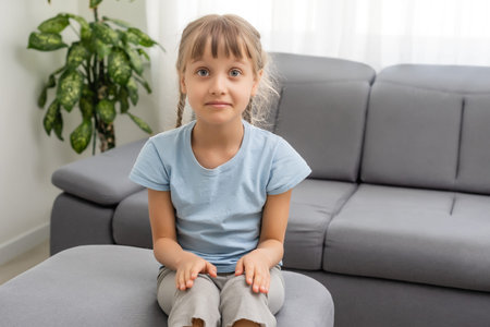 Adorable cute little vlogger looking at webcam, smiling child girl talking to camera making video...