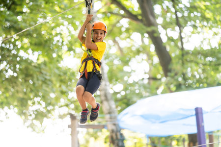 Happy child climbing in the trees. Rope park. Climber child. Early childhood development. Roping...