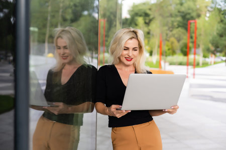Young woman with laptop outside