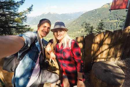tourism, travel, people, leisure and technology concept - happy international teenage couple taking...