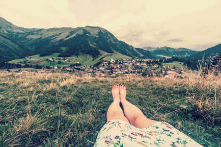bare female legs on the background of the alpine villageの写真素材