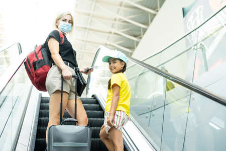 Mother and little daughter at airport terminalの写真素材