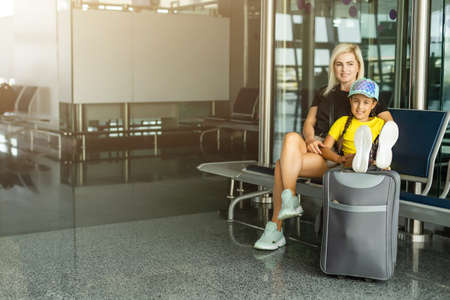 Family in airport. Attractive young woman and cute little daughter are ready for traveling. Happy family concept.の写真素材