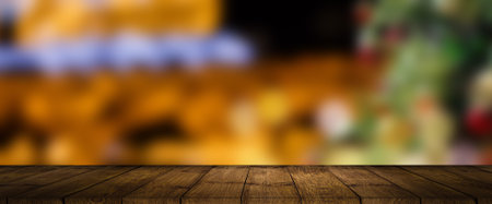 wooden Table and blur background, Christmas background with Christmas tree and gift.