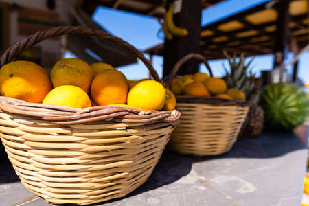 Baskets full of beautiful oranges for sale at the farmers market on a bright, sunny morning.の写真素材