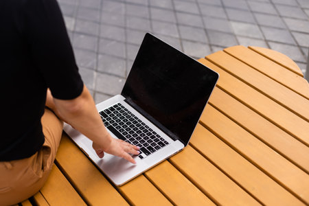 Young woman with laptop outsideの写真素材