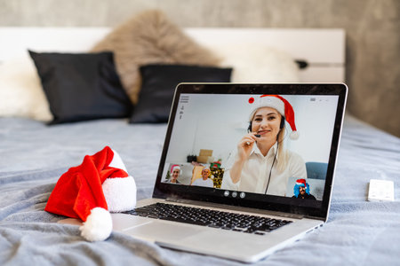 People on virtual call with family and friends exchanging gifts and celebrating virtual christmas...