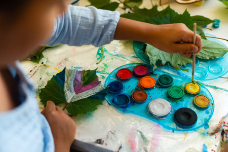 two schoolgirls paint the leavesの写真素材