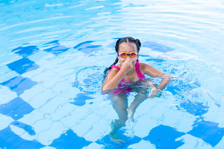 happy girl in the swimming in swimming suit