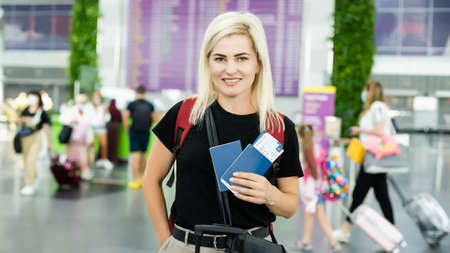 Young woman with passport at the airportの写真素材