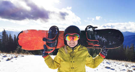 Young happy woman in snowy mountains. Winter sport vacation.の写真素材