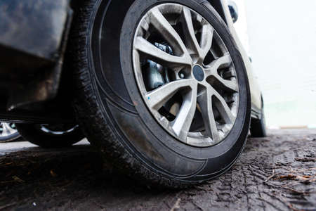 wheels of a white car in the mudの写真素材