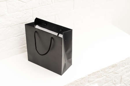 black paper bag with handles on a white backgroundの写真素材