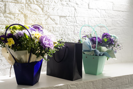 black gift box on bouquet of flowers