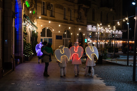 Lviv, Ukraine old town rynok market square alley in Lvov with winter Christmas illumination at night with snowのeditorial素材