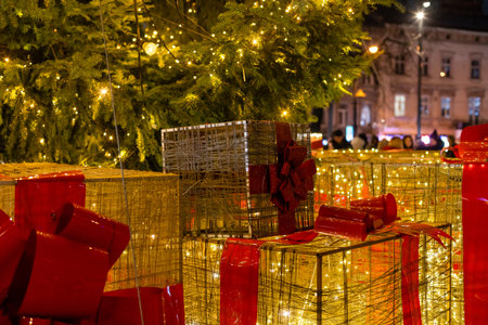 Outdoor Christmas holiday presents decorations gift boxes tied to tree on town street winter idea concept funの写真素材