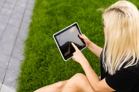 Happy young woman with digital tablet.