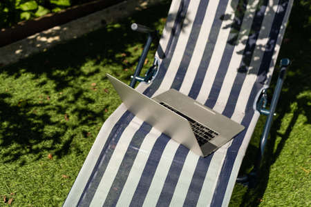 laptop on a sun lounger side viewの写真素材