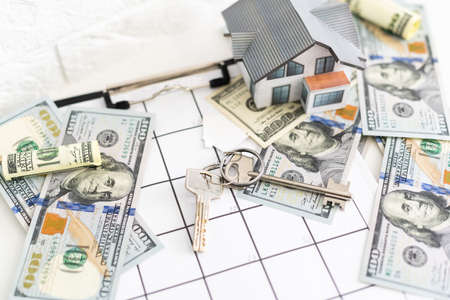 mortgage, investment, real estate and property concept - close up of home model, dollar moneyの写真素材