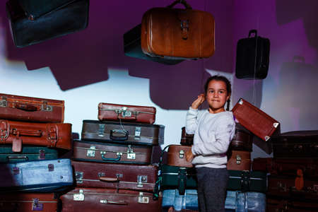 The little girl with old retro suitcases.の写真素材
