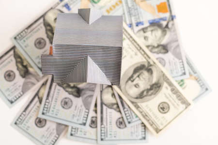 The house put on dollars banknote like a carpet. Concept of saving money to buy, rent, repair or renovation of housesの写真素材
