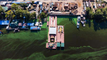 dirty green river with old garbageの写真素材