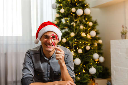 Young man celebrating Christmas in kitchenの写真素材