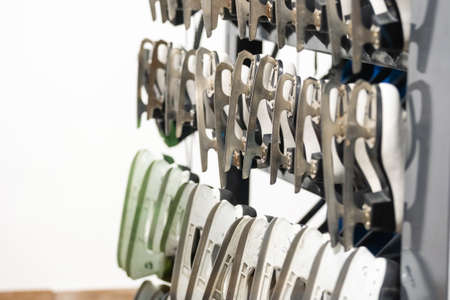 Rows of white ice skates. hire of winter sports equipment. shelves with skatesの写真素材