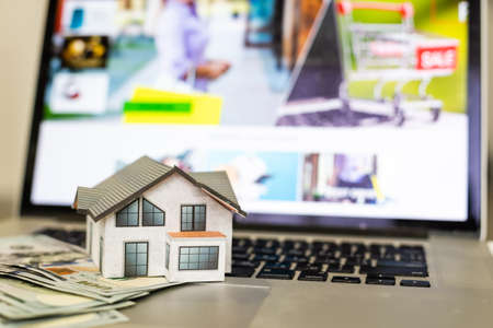 mortgage, investment, real estate and property concept - close up of home model, dollar moneyの写真素材