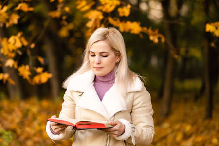 Women in outdoors reading Bible. Concept for faith, spirituality and religion. Peace, hopeの写真素材